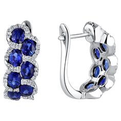 Indulge in the enchanting allure of these lever-back earrings, each adorned with seven mesmerizing oval-cut sapphires per earring, totaling an impressive 2.88 carats. The sapphires, reminiscent of the deep blue skies, are delicately nestled among a trail of brilliant round white diamonds, adding a touch of sophistication and glamour. The total diamond weight of 0.36 carats enhances the overall sparkle, creating a harmonious balance of color and brilliance. Seven oval-cut sapphires per earring, t Luxury Blue Hoop Earrings For Formal Occasions, Luxury Diamond Accented Earrings For May Birthstone, Luxury Blue Oval Jewelry, Luxury Blue American Diamond Jewelry, Luxury Blue Earrings With Polished Finish, Luxury Blue Earrings With Natural Stones, Luxury High Luster Blue Earrings, Luxury Sapphire Multi-stone Jewelry, Luxury Multi-stone Blue Jewelry