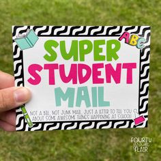 a hand holding up a sticker with the words super student mail written on it