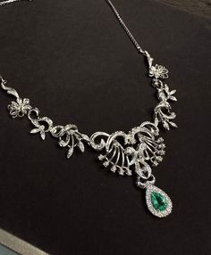 Elegant and exquisite, Victorian style necklace with diamonds in 18Kt white gold in symmetrical floral design, beautifully handcrafted. The center sits a sparkly, enchanting natural Colombian Emerald in pear cut, the emerald is 0.70 ct and has stunning luster, it is surrounded with a halo of natural brilliant white diamonds weight approx 0.2 ct. The necklace is a true beauty, ravishing and gleaming, the floral part was made with 9 hinged section, with millegrain setting details and dainty diamon Opulent Diamond Necklace With 17 Jewels, Opulent Diamond Necklace For Formal Events, Opulent Diamond Necklace For Formal Occasions, Formal Emerald Necklace With Brilliant Cut, Dazzling Formal Emerald Necklace Brilliant Cut, Dazzling Brilliant Cut Emerald Necklace For Formal Events, Exquisite Diamond And Emerald Formal Necklace, Luxury Emerald Necklace With Diamond Accents For Formal Events, Exquisite Emerald Necklace