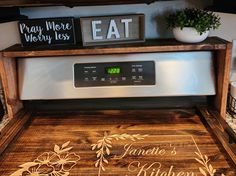 an oven with some signs on it and a potted plant in the corner next to it