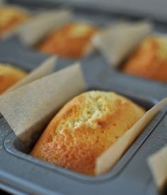 several muffins in plastic trays lined up