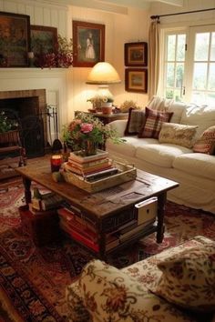 a living room filled with furniture and a fire place next to a window covered in pictures