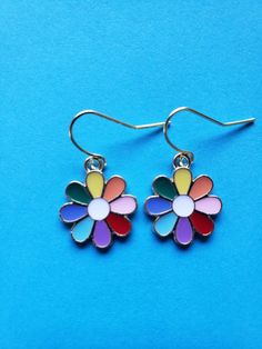 Do these multi color earrings bring a smile to your face? These  enamel rainbow/multi colored flower earrings are light weight and would match any outfit! Trendy Multicolor Flower Earrings, Trendy Multicolor Earrings For Spring, Trendy Colorful Earrings For Spring, Spring Multicolor Flower Earrings, Spring Flower Enamel Earrings, Trendy Colorful Spring Earrings, Colorful Dangle Earrings For Spring, Summer Multicolor Earrings With Flower Charm, Spring Multicolored Dangle Earrings