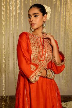 Orange anarkali with placed thread embroidered floral paisley motifs embellished by sequins. Comes with matching dogri salwar.
Components: 2
Pattern: Embroidered
Type Of Work: Thread, Sequin
Neckline: Notched
Sleeve Type: Three quarter
Fabric: Silk Dupion
Color: Orange
Other Details: 
Flared silhouette
Occasion: Sangeet,Mehendi and Haldi - Aza Fashions Festive Unstitched Anarkali Set With Resham Embroidery, Anarkali Kurta With Intricate Embroidery In Dola Silk, Designer Floor-length Kurta With Intricate Embroidery, Dola Silk Anarkali Set With Intricate Embroidery, Designer Anarkali Set With Intricate Embroidery, Festive Salwar Kameez With Zari Work For Reception, Festive Floor-length Kurta With Intricate Embroidery, Transitional Reception Salwar Kameez With Zari Work, Dola Silk Kurta With Intricate Embroidery For Reception