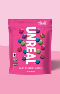 a bag of unreall chocolate candy on a pink background