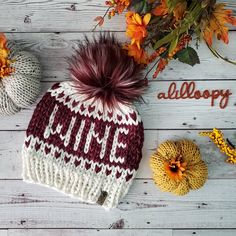 a knitted hat with the word happy written on it next to fall leaves and pumpkins