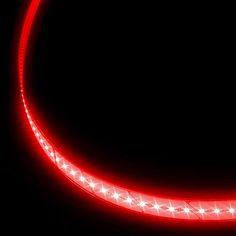 a close up of a red light on a black background with stars in the middle