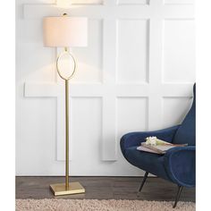 a lamp that is sitting on top of a rug next to a chair and table