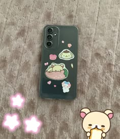 a phone case with an animal sticker on it next to a star shaped object