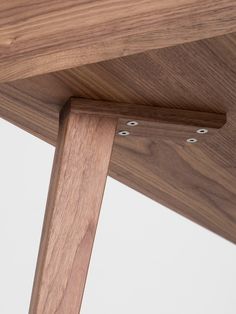 a close up view of the underside of a wooden chair with metal rivets