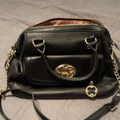 Beautiful Black Shoulder Bag,Never Been Used, No Tags But Is New. Black Travel Satchel With Metal Hardware, Black Satchel With Metal Hardware For Travel, Black Satchel With Metal Hardware For Evening, Black Evening Satchel With Metal Hardware, Black Satchel Bag With Metal Hardware, Black Satchel With Gold-tone Hardware Shoulder Bag, Black Satchel With Metal Hardware And Double Handle, Black Satchel With Gold-tone Hardware, Black Crossbody Satchel With Metal Hardware