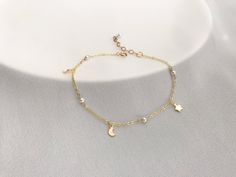 The pearl bracelet/ Anklet is hand-crafted using Premium Crystal Pearls and gold-filled charm. This Moon and Star bracelet is perfect for bridesmaid wedding gift, birthday gift and friends or any occasion. Bracelet Length :   16.5 , 17.5 cm, 17.5cm+2.5cm extension chain .  Anklet Length: 23cm+2.5 cm,  24cm + 2.5cm.  Material: gold filled Moon, Star charms, 3mm white Premium Crystal Pearl  (4 pearls) gold filled chain and gold filled findings.  Moon Charm: Length with loop: 7mm  Wide: 4mm Star Ch Gold Charm Bracelet With Moon Charm As A Gift, Dainty Gold Bracelets With Moon Charm, Dainty Gold Bracelet With Moon Charm, Moon And Star Bracelet, Delicate Wedding Jewelry, Delicate Gold Bracelet, Silver Bracelet Designs, Bracelets Friendship, Gold Pearl Bracelet