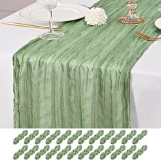 green table runner with white plates and silverware