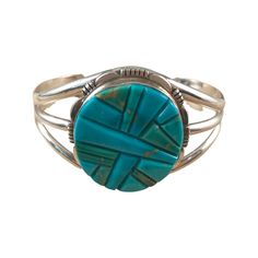 This is one powerful vintage turquoise cuff bracelet! It's a Native American, artist signed piece with a great mosaic of turquoise made from blue and a light green turquoise. The setting has some stunning metal work and is a beautiful piece of Native American Jewelry. The artist is Thomas Francisco, a Navajo artist, and his signature, along with a sterling mark and arrow are on the back. This is a solid piece, but can be slightly molded/adjusted to your wrist. Please see the measurements below. This piece originally retailed for $575! You can still see the wax pencil marking on the back just barely.  | MEASUREMENTS | Length: 2 1/2" across the center (measure your wrist from wrist bone to wrist bone to see if this will fit), opening is 1 1/2" (measure the thickness of your wrist) Width: 2" Southwestern Style Turquoise Cuff Bracelet, Southwestern Style Round Turquoise Cuff Bracelet, Artisan Round Turquoise Cuff Bracelet, Artisan Turquoise Bracelets With Inlay, Artisan Turquoise Bracelet With Inlay, Southwestern Style Turquoise Inlay Bracelets, Southwestern Turquoise Inlay Bracelet, Bohemian Turquoise Inlay Cuff Bracelet, Southwestern Style Turquoise Cuff Bracelet With Inlay