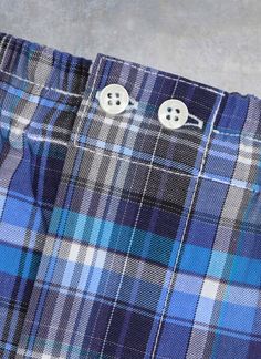 The styling of our woven Perfect Boxer in Blue and Grey Plaid has been meticulously honed to provide the perfect rise and fit. The fit does away with all excess, baggy fabric and is as comfortable when worn under a pair of slim 5-pocket jeans as under dress pants. Our boxer features bespoke details found only in exclusive custom-made boxers. There are two operable buttons at the waist, as well as a functional fly opening. The waistband elastic is fully covered with pleated fabric running the len Classic Blue Bottoms With Button Closure, Everyday Blue Bottoms With Button Closure, Shirting Fabric, Grey Plaid, Promotional Events, Blue And Grey, Pleated Fabric, Under Dress, Boxer Shorts