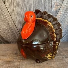 a ceramic turkey sitting on top of a wooden table