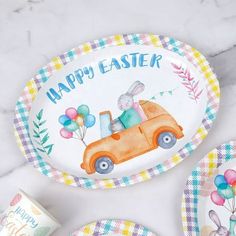 an easter themed plate and coasters on a marble countertop with bunny in car