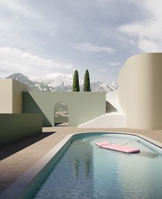 a pink object floating on top of a swimming pool next to a white building with mountains in the background