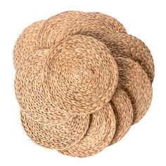 three round straw placemats stacked on top of each other in the shape of circles