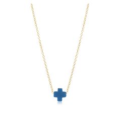 a small blue cross necklace on a gold plated chain, with a white background