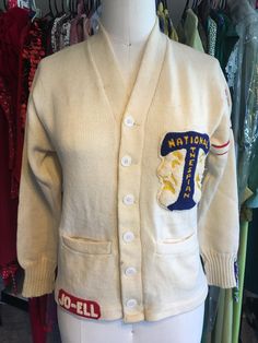 "1960s vintage letterman sweater. All wool off white. Puritan Sportswear \"Natch\". \"National thespian\" patch with comedy and tragedy masks. \"Jo-ell\" patch. \"63\" patches with red/white stripe around arm. Preppy. Varsity. Fits like women's S. Garment is in perfect vintage condition. There are a few small stains here and there. Freshly laundered and ready to wear! Measurements are as follows: (taken while lying flat) Shoulder = 15\" Pit to pit = 17 1/2\" Hem opening = 17 1/2\" (half measurem Vintage White Sweater For College, White Vintage Sweater For College, White Cardigan For College In Fall, White Fall Cardigan For College, White Collegiate Winter Sweater, Vintage Long Sleeve Wool Varsity Jacket, Vintage White Sweater With Ribbed Cuffs, Retro White Cotton Cardigan, White Cotton Retro Cardigan