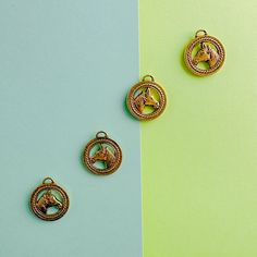 three pieces of jewelry sitting on top of a green and blue surface