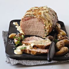 a piece of meat sitting on top of a black plate