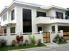 a white two story house with lots of windows