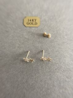 14K Solid Gold Tiny CZ Two Star Stud Earrings - 14K Solid Gold Quantity: One Pair Color : Gold Materials : 14K Solid Yellow Gold Size : 6mm*10mm *14K Solid Yellow Gold will not tarnish. *Good for sensitive skin. * Metal components are 14K Solid Yellow Gold including earring backs. * Suitable for delicate and sensitive ears. * Comes in a jewelry box. If you need extra boxes for gifting....just let us know! Gold Star-shaped Earrings With Diamond Accents, Gold Star Earrings With Diamond Accents, Star Stud Earrings, Star Earrings Stud, Cz Stud Earrings, Cartilage Piercing, Star Studs, Gold Price, Small Earrings