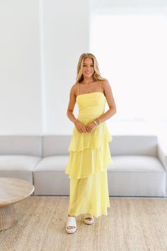 Introducing the Bailey Ruffle Tiered Maxi Dress in Yellow! Elevate your summer wardrobe with this stunning dress featuring delicate ruffle details and a tiered design. Perfect for any occasion, this dress will make you feel confident and stylish. Get yours today! Size Recommendations 0-2:S, 4-6:M, 8-10:L Pastel Yellow Bridesmaid Dresses, Pastel Maxi Dresses, Light Yellow Dresses, Yellow Long Dress, Yellow Bridesmaid Dresses, Banquet Dresses, Prom Dress Inspiration, Winter Formal