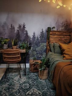 a bedroom with a bed, desk and chair in front of a forest wall mural