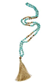 Show off boho-chic style in this long necklace composed of mixed beads in earthy hues with a tassel pendant. 38" length; 3 1/2" pendant 14k-gold plated brass/glass Imported Adjustable Bohemian Long Necklace With Tassels, Bohemian Long Necklace With Tassels, Bohemian Beaded Lariat Necklace With Tassels, Bohemian Lariat Beaded Necklace With Tassels, Blue Bohemian Hand Knotted Necklaces, Blue Bohemian Hand-knotted Necklaces, Turquoise Necklace With Tassels And Round Beads, Turquoise Necklaces With Tassel And Round Beads, Bohemian Beige Jewelry For Meditation