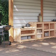 an outdoor bbq with grill, table and chairs next to it on a patio