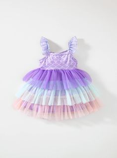 Dive into enchanting style with our Baby Girl's Mermaid Tail Pattern Color Block Mesh Layered Frilled Hem Spaghetti Strap Dress! This mesmerizing ensemble features a whimsical mermaid tail pattern combined with a delightful color block design, creating a look that's as magical as it is adorable. The mesh layered frilled hem adds an extra touch of charm, perfect for your little one's twirl-worthy moments. With adjustable spaghetti straps for a comfortable fit, this dress is ideal for any special Pink Mermaid Dress For Summer, Pink Sleeveless Mermaid Dress For Summer, Sleeveless Pink Mermaid Dress For Summer, Pink Mermaid Dress For Spring, Purple Mermaid Hem Summer Dress, Purple Ruffled Mermaid Dress, Princess Sleeveless Mermaid Dress With Ruffles, Princess Style Sleeveless Mermaid Dress With Ruffles, Purple Sleeveless Mermaid Dress For Summer