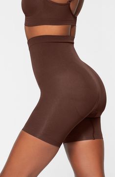 Sculpt your body's natural shape with shaping shorts that hit just above the knee with a whisper-soft and seamless design from Kim Kardashian's SKIMS. Reflecting the brand's passion for highly technical shapewear solutions for every body, this staple piece smoothes your upper legs while lifting your butt and comes in different shades to complement your skin tone. 5" regular inseam Cotton-lined gusset 82% nylon, 18% elastane Machine wash, tumble dry Made in Turkey Shapewear With Built-in Bra In Short Shape, Solid Shapewear With Built-in Bra, Short Shape, Compressive Smoothing Mid-thigh Shapewear, Smoothing Compressive Mid-thigh Shapewear, Solid Color Shapewear With Built-in Bra, Compressive Shapewear With Smoothing, Short Length, Compressive Smoothing Shapewear Shorts, Short Compressive Shapewear For Smoothing, Compressive Smoothing Shapewear In Short