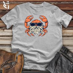 Unleash your inner beach bum with our Crab Coastal Hipster Sandy Style Cotton Tee. This quirky shirt features a cool crab design that'll make you stand out at any coastal event. Made with comfortable cotton, you'll be stylish and laid-back at the same time. 100% Airlume combed and ring spun cotton Machine wash cold with like colors, dry low heat. *THIS PRODUCT WILL SHRINK* Lightweight, Classic unisex fit, Double-needle sleeve and bottom hem Boots & Jeans pictured are sold by Origin, a Pete Rober Crab Design, Vintage Beanie, Boots Jeans, The Crab, Old Shirts, Quirky Design, Trendy Shirts, Beach Bum, Cool Cats