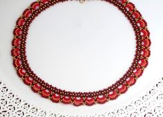 "I created this red jewelry set by hand, using red, Burgundy, and orange Miyuki round seed beads. * Measurements: Necklace length: 16.5\" (42cm) Necklace height : 0.59\" (1.5cm) Earring length: 1.57\" (4cm) Fan element diameter: 1.18\" (3cm) * All necklace comes with an extension chain. *Additional information on matching earrings you can see here: https://www.etsy.com/il-en/listing/231317680/red-dangle-earrings-red-and-orange?ref=shop_home_active_41 *The jewelry will come beautifully packaged f Red Jewelry Set, Formal Earrings, Red Beaded Necklaces, Red Jewelry, Necklace Red, Hand Craft, Seed Bead Necklace, Seed Bead Earrings, Red Bead