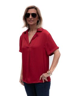 Take a look at our beautiful Ruby Red Notch Collar Short Sleeve Blouse Soft silky fabric Super soft 100% microfiber fabric Color: Ruby Red Semi loose body with short sleeves Notch collar with a pleat detail in the front Back has a yoke and decorative small buttons Center back length is 25" Classic Short Sleeve Viscose Blouse, Versatile Short Sleeve Viscose Blouse, Versatile Viscose Short Sleeve Blouse, Short Sleeve Viscose Blouse, Classic Collared Rayon Tops, Solid Color Relaxed Fit Short Sleeve Blouse, Solid Color Short Sleeve Relaxed Fit Blouse, Solid Color Short Sleeve Blouse With Relaxed Fit, Chic Short Sleeve Viscose Blouse