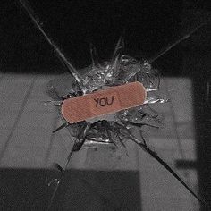 a piece of glass with the word you on it that has been shattered and is sitting on a table