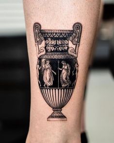 a black and white tattoo on the leg of a person with a vase in it