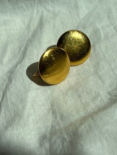 "Vintage from 1960s. Pretty, simple, everyday, gold, earrings. I believe these are made from brass. Medium size. Clip on earrings. Great, button, classic, post, circle, earrings. Made from brass and metal. Almost looks gold but I believe is brass. In good condition. Has scratches and patina. Sold as is.** No returns or refunds. measurements: 3/4\" L x 5/8\"W" Everyday Gold Earrings, Vintage Gold Mirror, Gold Rhinestone Earrings, Vintage Gold Necklace, Vintage Rhinestone Earrings, Vintage Gold Earrings, Butterfly Necklace Gold, Romantic Earrings, Gold Earrings Wedding