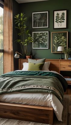 a bedroom with green walls and pictures on the wall above the bed, along with an area rug