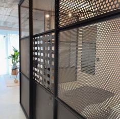 an office cubicle with metal mesh partitions