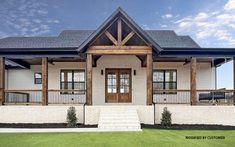 a white brick house with wood trim and windows