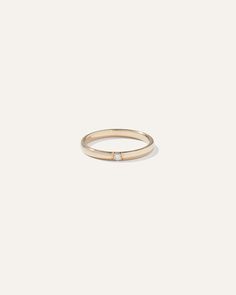 a gold ring with a single diamond in the middle