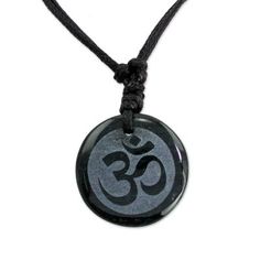 Carved from dark green jade â so dark it seems black â the Om symbol of Lord Shiva flourishes like ancient calligraphy. This mantra is used in mystical contemplation of ultimate reality and is considered the resonant body of the absolute. From Jorge Lopez the elegant pendant is worn on a black leather necklace. Its length can be adjusted by sliding the knots along the cords.Please note: Etched image may fade somewhat over time as a result of absorbing body oils and/or skincare products. Simp Symbolic Black Jewelry For Healing, Symbolic Black Jewelry For Gift, Symbolic Black Jewelry For Gifts, Symbolic Black Round Jewelry, Engraved Spiritual Black Jewelry, Engraved Black Spiritual Jewelry, Spiritual Black Necklace For Festivals, Black Round Spiritual Jewelry, Adjustable Black Amulet Necklace