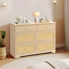 a white bed sitting next to a wooden dresser with baskets on it's drawers