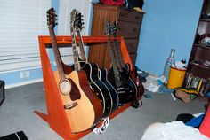 guitars are lined up on a shelf in a bedroom