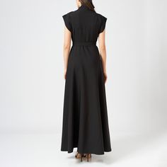 This bias-cut wrap dress is crafted from a soft fabric, falling elegantly to ankle length. The dress wraps around the body, cinching the waist with a matching tie belt, and is fitted at the bust and waist for a flattering, feminine silhouette.  The top of the dress features intricate hand embroidery, adding a delicate touch to the sleek design. It has a V-neckline, balancing the detailed embroidery with a minimalist, tailored look.  The bias cut allows the fabric to drape naturally over the body Elegant A-line Wrap Dress For Evening, Pre-draped Formal Maxi Dress, Elegant Fitted Maxi Dress With Cape Sleeves, Elegant Long Fitted Wrap Dress, Fitted Maxi Length Cocktail Wrap Dress, Elegant Long Wrap Dress For Formal Occasions, Linen Maxi Dress For Work, Elegant Fitted Maxi Wrap Dress, Fitted Maxi Wrap Dress For Evening