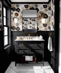 a black and white bathroom with floral wallpaper